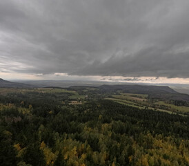 Autumn rainy sky over mountains, autumn mountains from above. Drone view. Poland, Table Mountains.