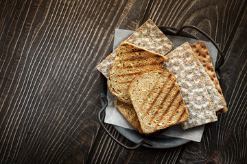 Plain roasted toast bread slices and crackers top view on table