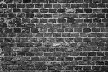 Black and white brick wall texture background ideal for architectural design, urban themes, and vintage style concepts.