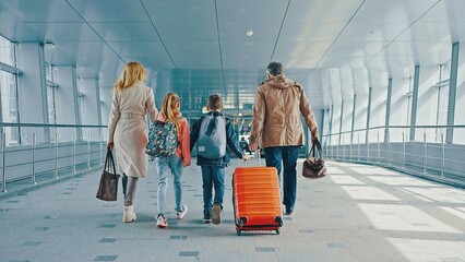 Airport, family and children excited for flight with suitcase on holiday, vacation or immigration journey and travel. Luggage of mother, father and their children excited for vacation. Back View.  © Ibn