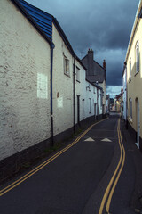 Narrow Street in Honiton, Devon, England, with Overcast Sky