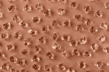 Pattern of ice pieces on Mocha brown background. Selective focus. . Demonstrating color of 2025 year