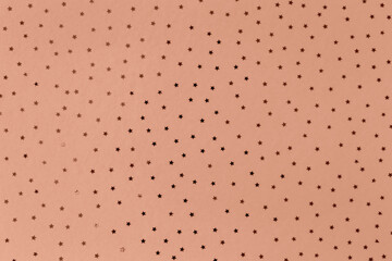 Pattern of small stars on Mocha brown background. Selective focus. Demonstrating color of 2025 year