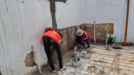 Construction workers are renovating the walls of building