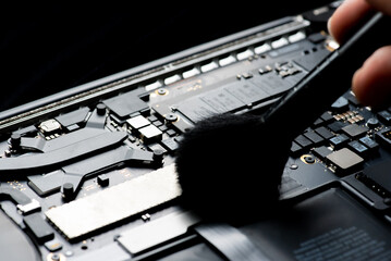close up of Technician repairing electronic circuit board,Cleaning the Interior of a Laptop Computer