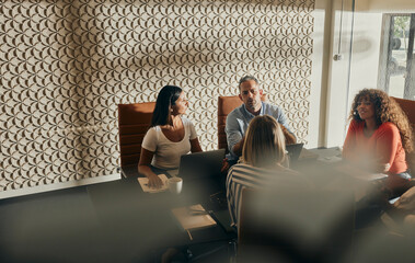 Diverse Team Engaged in Productive Business Meeting Discussion in Modern Office