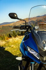Front view of a motorcycle with mountains in the background.