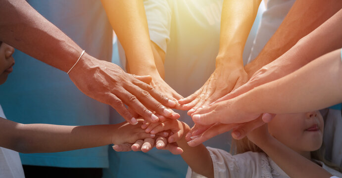 Hands of diversity volunteer people join hands together for help garbage collection charity outdoor. Volunteer and charity environment concept