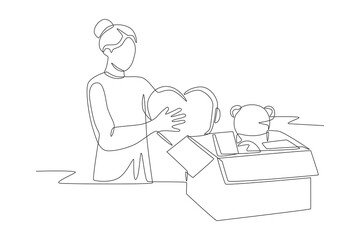 Woman packs toys for donation. Organizing toy drives concept one-line drawing