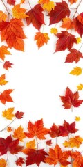 Obraz premium Border of vibrant autumn leaves in shades of red, orange, and yellow on a white background, copy space