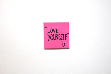 Motivational and love message on a sticky notes with isolated white background.