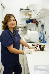 Dental technician working with materials in a laboratory.
