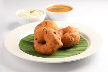 Medu Vada, a popular South Indian food served with Sambar ,Green coconut chutney ,Vada ,Medu vadai with sambar - Popular South Indian snack