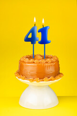 Number 41 Candle - Happy Birthday Cake on a yellow background.