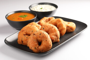 Medu Vada, a popular South Indian food served with Sambar ,Green coconut chutney ,Vada ,Medu vadai with sambar - Popular South Indian snack