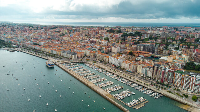Spectacular aerial view of Santander Port. Panoramic view over promenade of the city. Turquoise water colour. Famous travel destination in North of Spain. Cloudy day. Aerial photography.