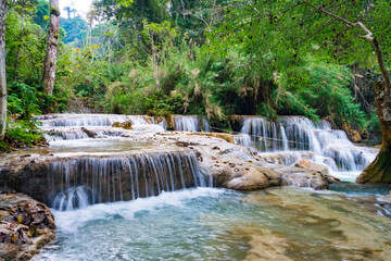 Naklejka premium Kuang Si Waterfalls Luang Probang Laos. long exposure. Beautiful scenery. Waterfall in the wild jungle. Asian nature.