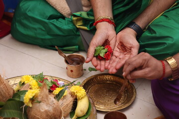 close up of hands performing pooja in indian tradition
