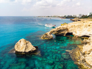 The Blue Lagoon on Cyprus Island tropical sea beach Cavo Greco in morning. Natural stone rock love bridge