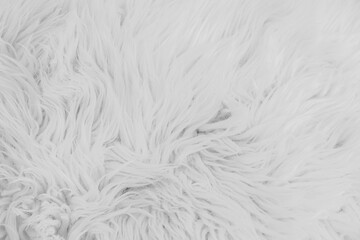 Cozy winter background with soft white fur and holiday decorations