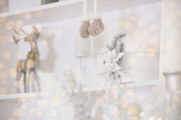 Cozy holiday decoration featuring silver reindeer and white floral accents