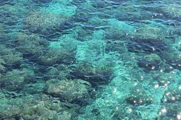 Scenic view of clear turquoise sea water with sunlight reflections