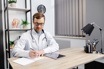 Portrait of young doctor wearing glasses and white uniform with stethoscope, speaking and...