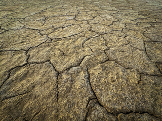 View of cracked, dry earth showcasing effects of prolonged drought on environment and climate.