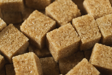 Macro cubes of brown cane unrefined demerara sugar.