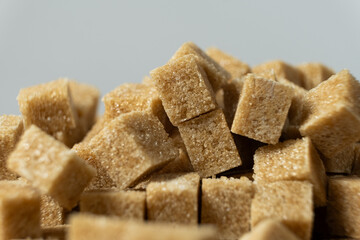 Macro cubes of brown cane unrefined demerara sugar.