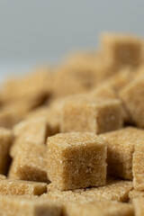 Macro cubes of brown cane unrefined demerara sugar.