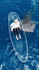 whale shark (Rhincodon typus) approaching a boat seen from a drone, Aerial view from the drone, Whale Shark Tourist Attraction in Botubarani Village.