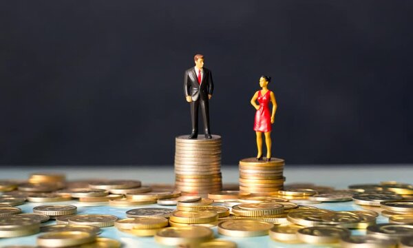 gender pay gap inequality concept with coins and miniature figure