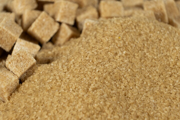 Brown cane unrefined demerara sugar in the form of crystals and cubes
