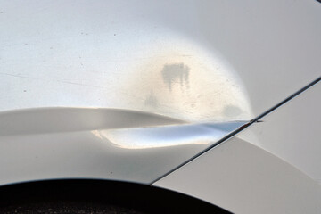 Dented car body, damaged front fender, collision on parking lot. Accident damage and auto body...