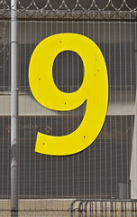 Number nine in metal on metallic grid