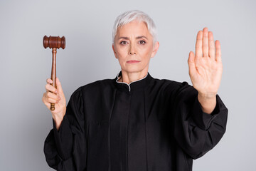 Photo of woman judge hold gavel show stop bribe corruption sign isolated grey color background