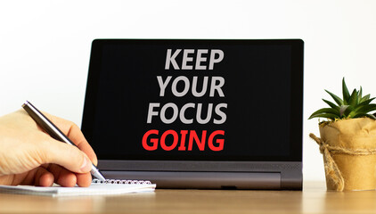 Keep your focus going symbol. Concept words Keep your focus going on beautiful black tablet. Beautiful white background. Businessman hand. Business and keep your focus going concept. Copy space.