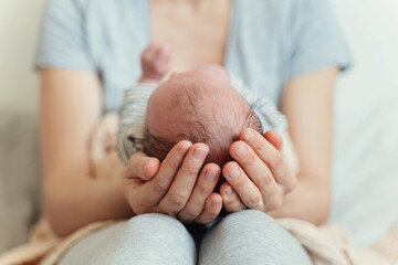Newborn in mother's hands. Baby care.
