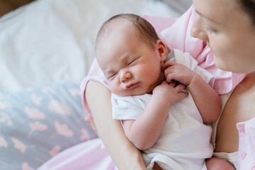 Baby sleeping in arms of his loving mother. Baby care.