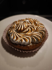 Delicious lemon meringue pie resting on white plate