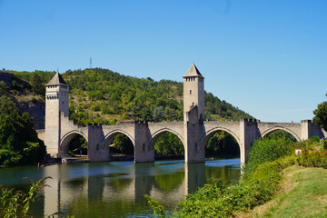 Fototapeta premium Valentré Bridge, Cahors, France. Old medieval stone crossing the Lot River. It is an exceptional example of medieval defensive architecture, and is the symbol of the town of Cahors.
