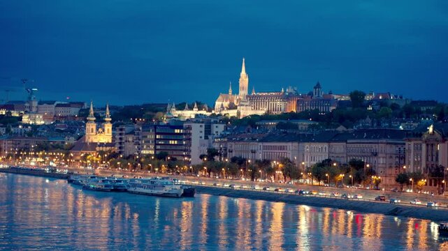 Fisherman's Bastion with Matthias Church Gothic Architecture.Street lights glowing and reflection on the Danube River. Night view from the Margit Bridge on Danube river. Cityscape of Budapest.