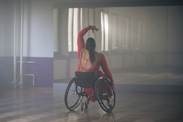 Beautiful dance in a wheelchair of a woman with disability at a dancing studio. Para dance sport. © 24K-Production