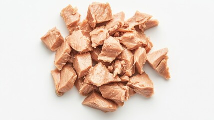 Canned tuna chunks arranged on a white background showcasing fresh textures and natural colors for culinary use or recipe styling