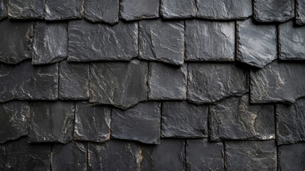 Detailed close-up view of textured black bitumen shingles on a residential roof, emphasizing the pattern and material quality, construction, real estate, home improvement.
