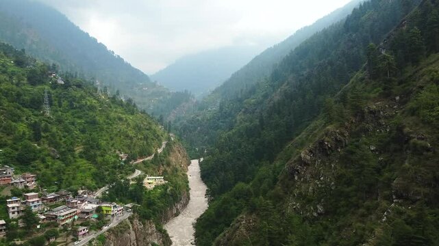 Aerial view of manikaran town with the parvati river and local houses in the parvati valley at himachal pradesh state of India.