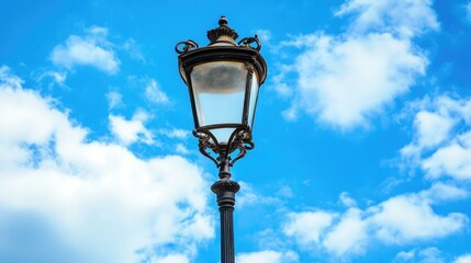 Vintage ornate street lamp against a bright blue sky showcasing classic design and architectural beauty in urban settings.
