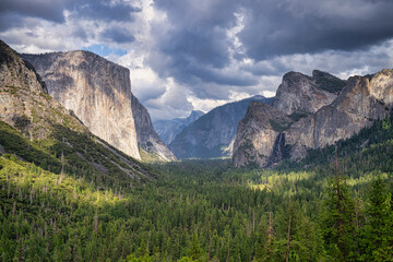 Scenic view of the Yosemite Valley from Tunnel View in the Yosemite National Park, Sierra Nevada mountains, as the sun lights up parts of the valley