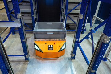 Warehouse robot. Automatic fulfillment cart. Warehouse robot with parcel container. AGV for moving...